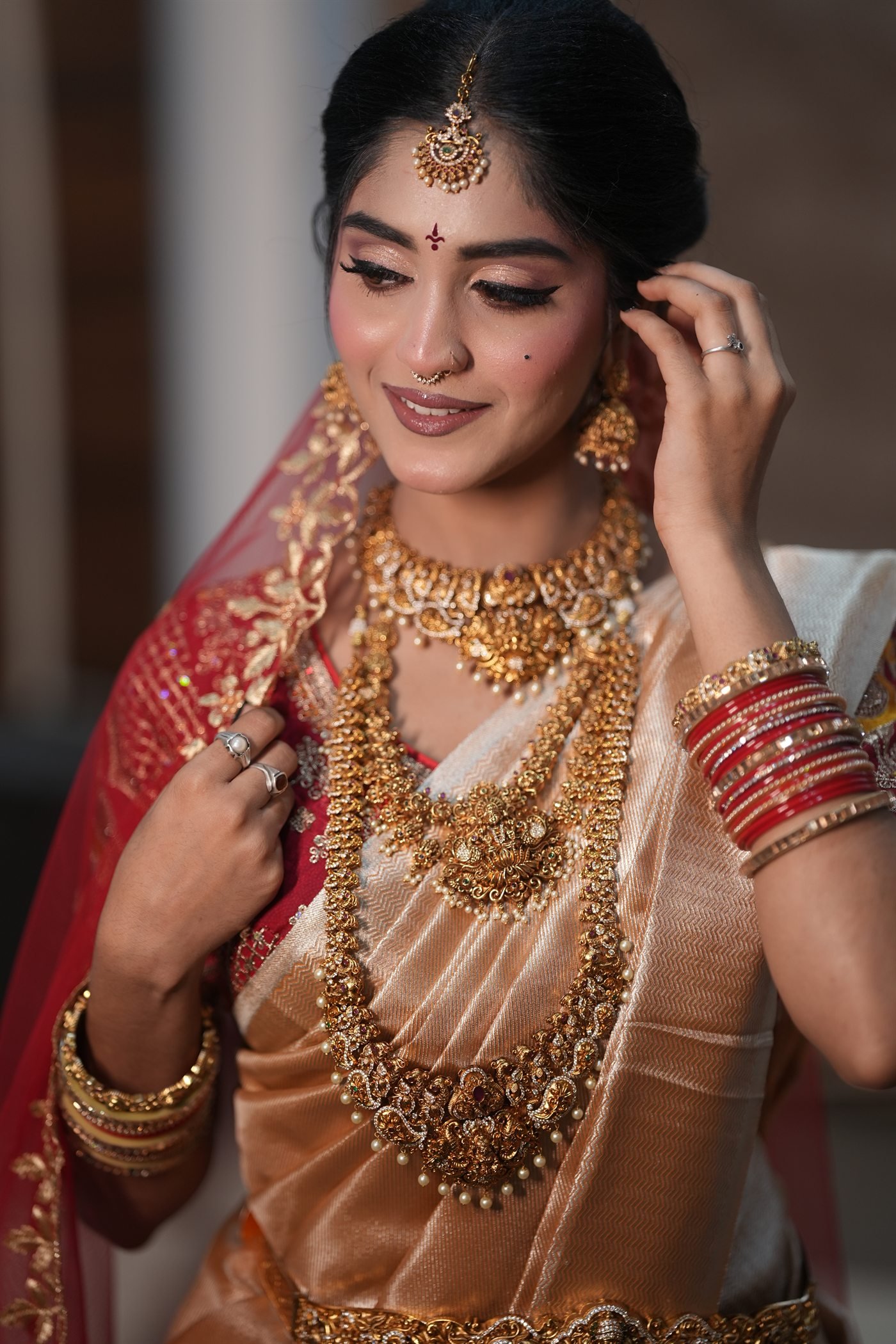 Close-up red and gold bridal makeup look