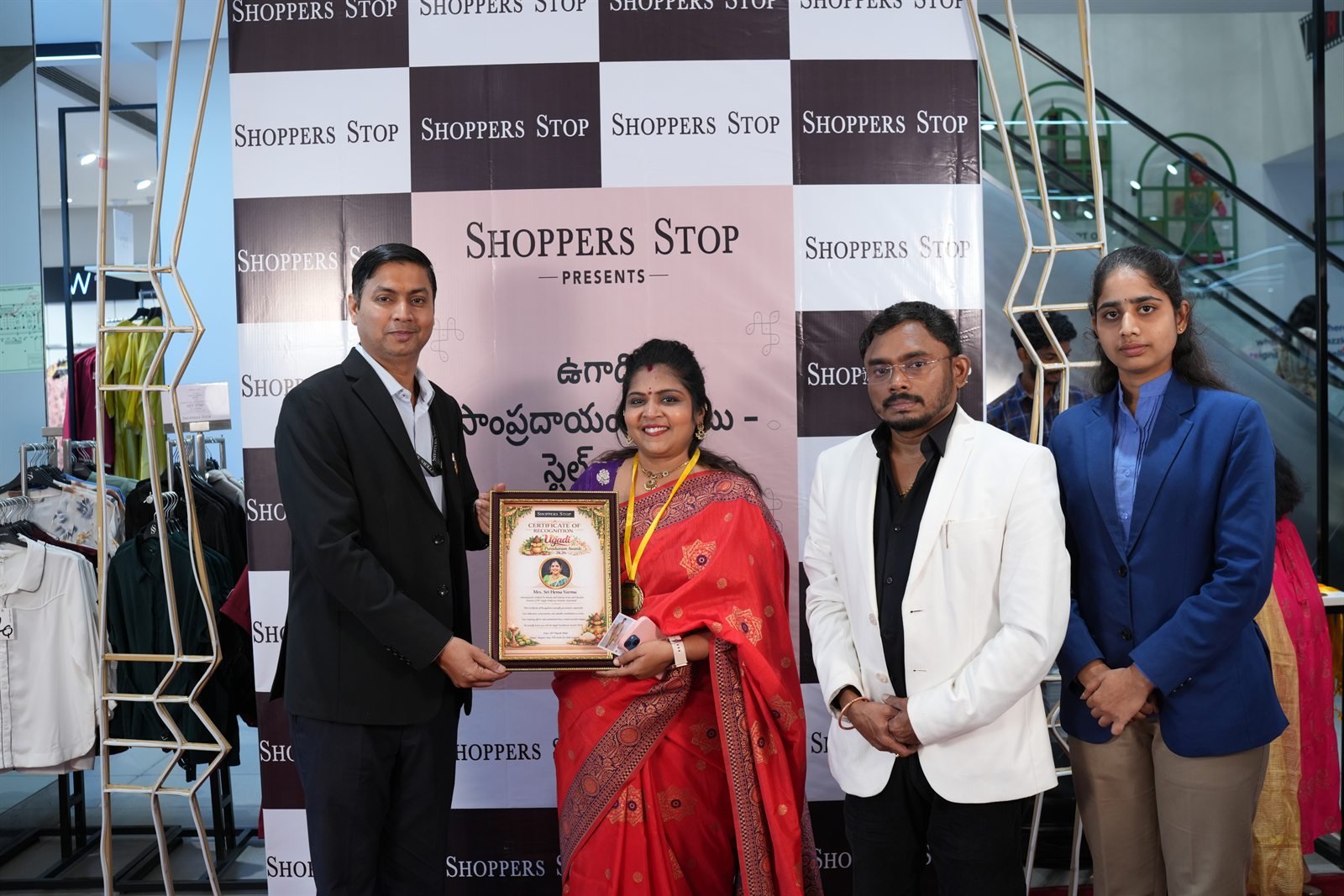 HV Angels trainer receiving the Ugadi Utsav award at Shoppers Stop
